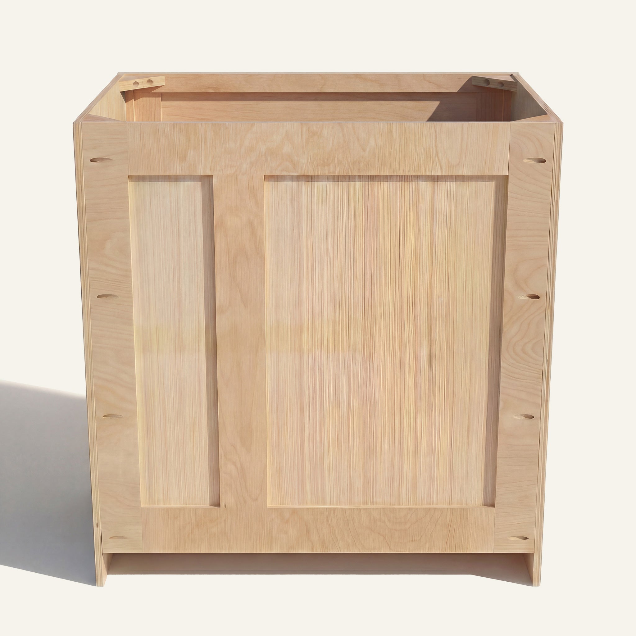 Rear view of a natural Seaport vanity with offset plumbing supports, pocket screw holes, and builder grade plywood construction.