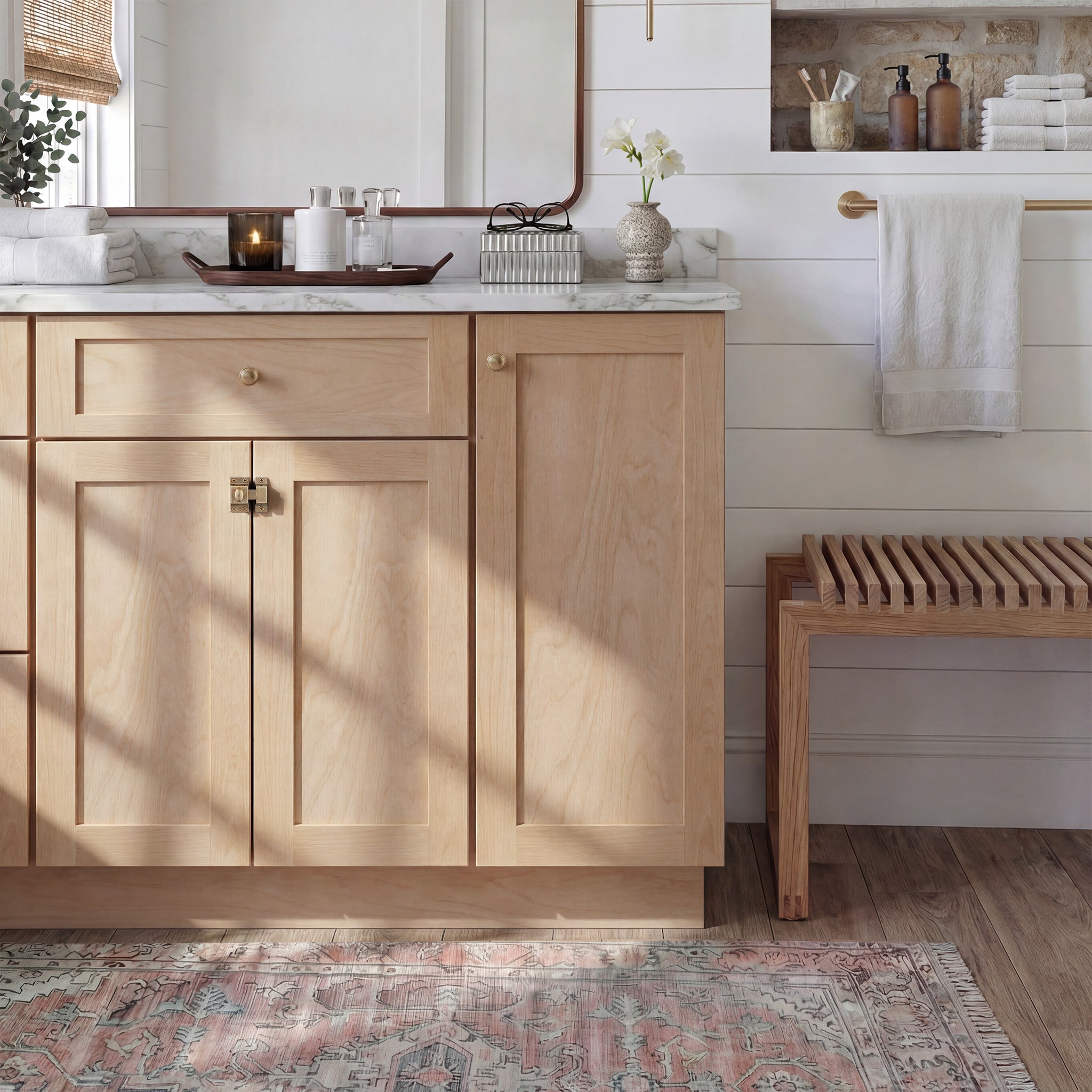Front view of a natural Seaport traditional vanity base cabinet with 3 doors and 1 drawer in a styled bathroom.