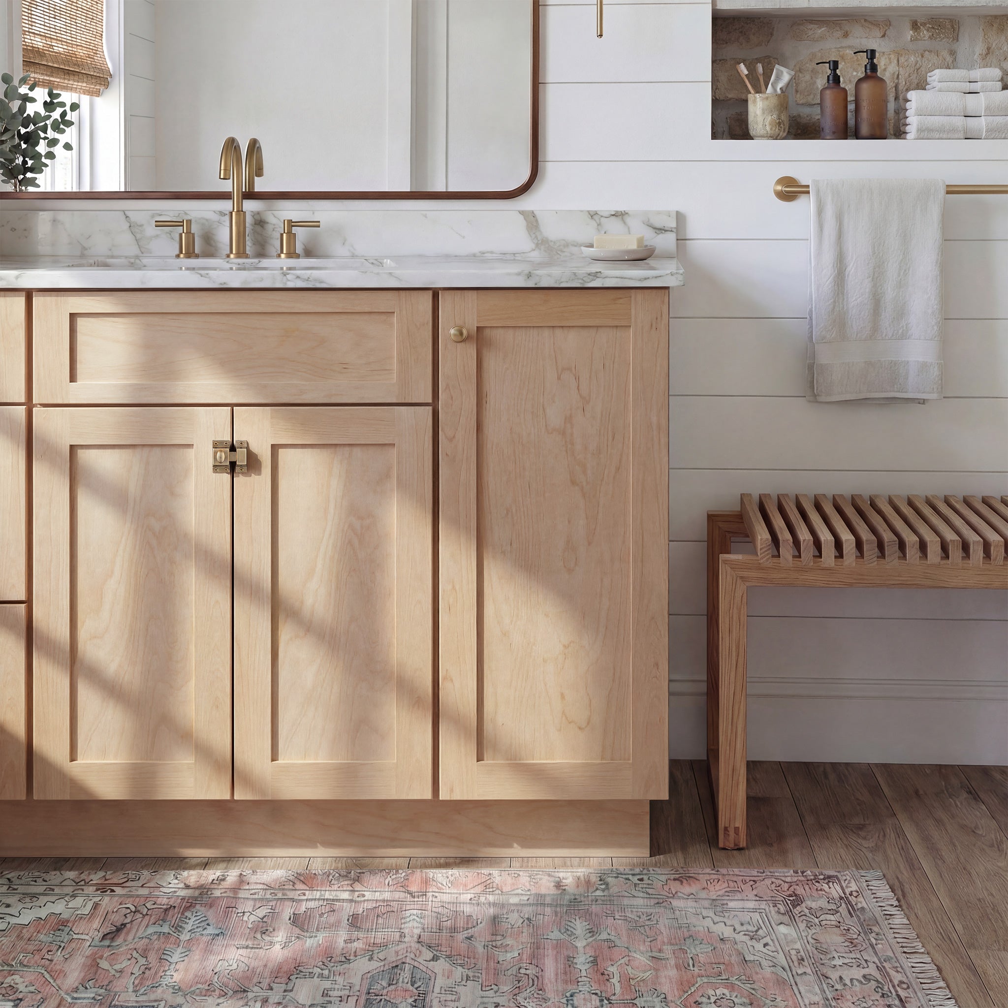 Front view of a natural Seaport traditional vanity base cabinet with 3-doors and 1 false drawer in a styled bathroom.