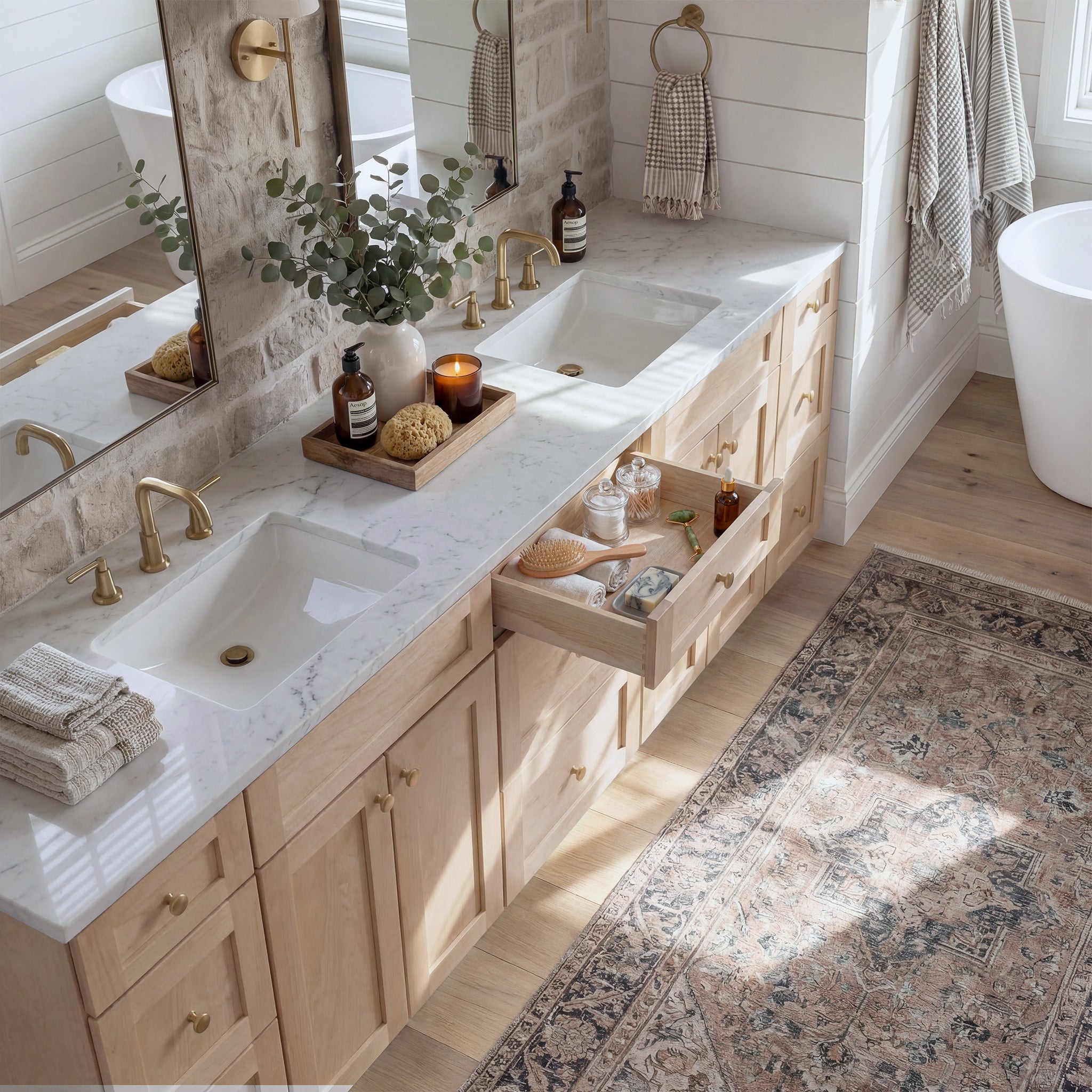 Top-down angled view of a natural Seaport shaker vanity with an open drawer, lived-in feel, and Mont Blanc quartzite counter.