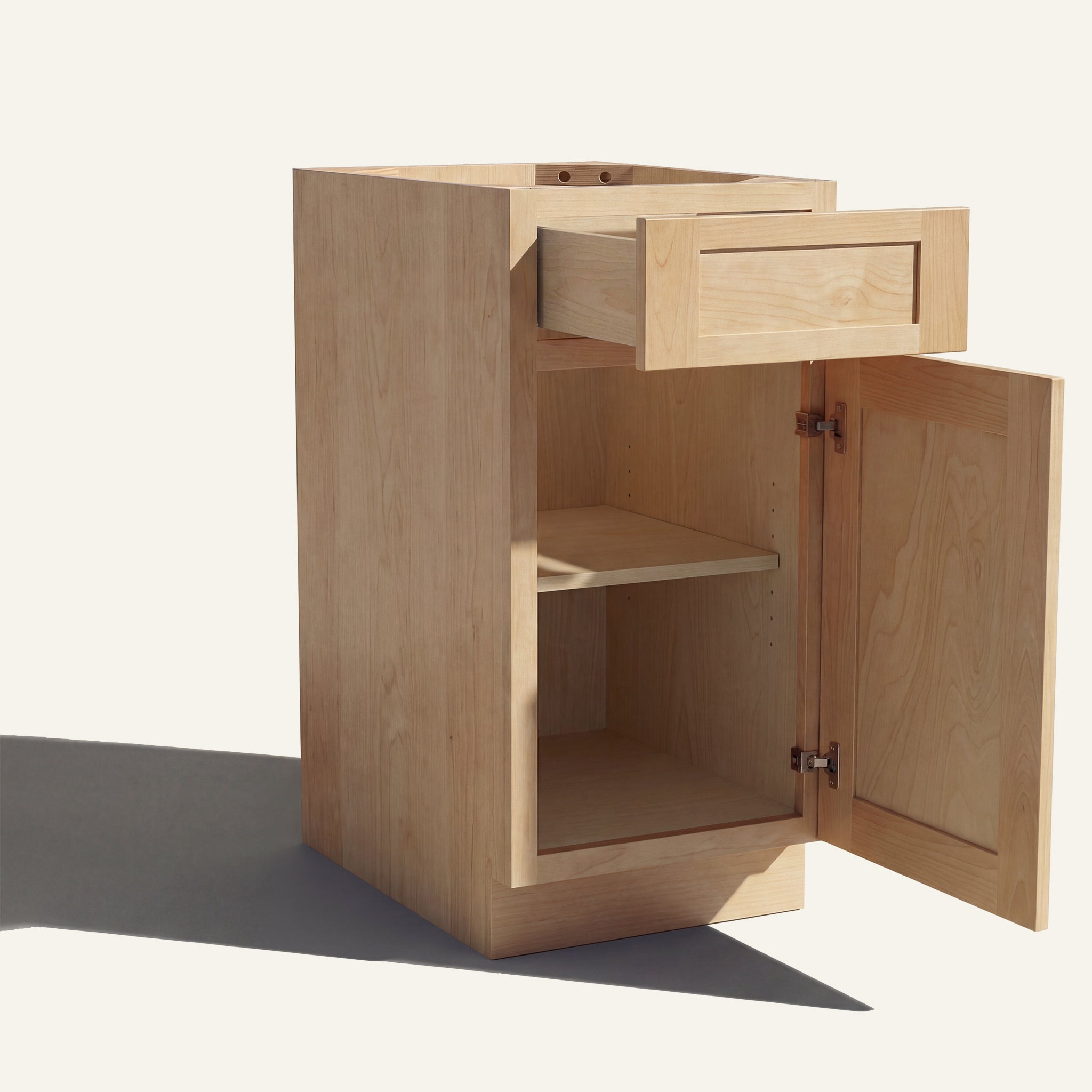 Angled view of a natural Seaport Shaker vanity base cabinet with 1 door and 1 drawer open showing wood interior.