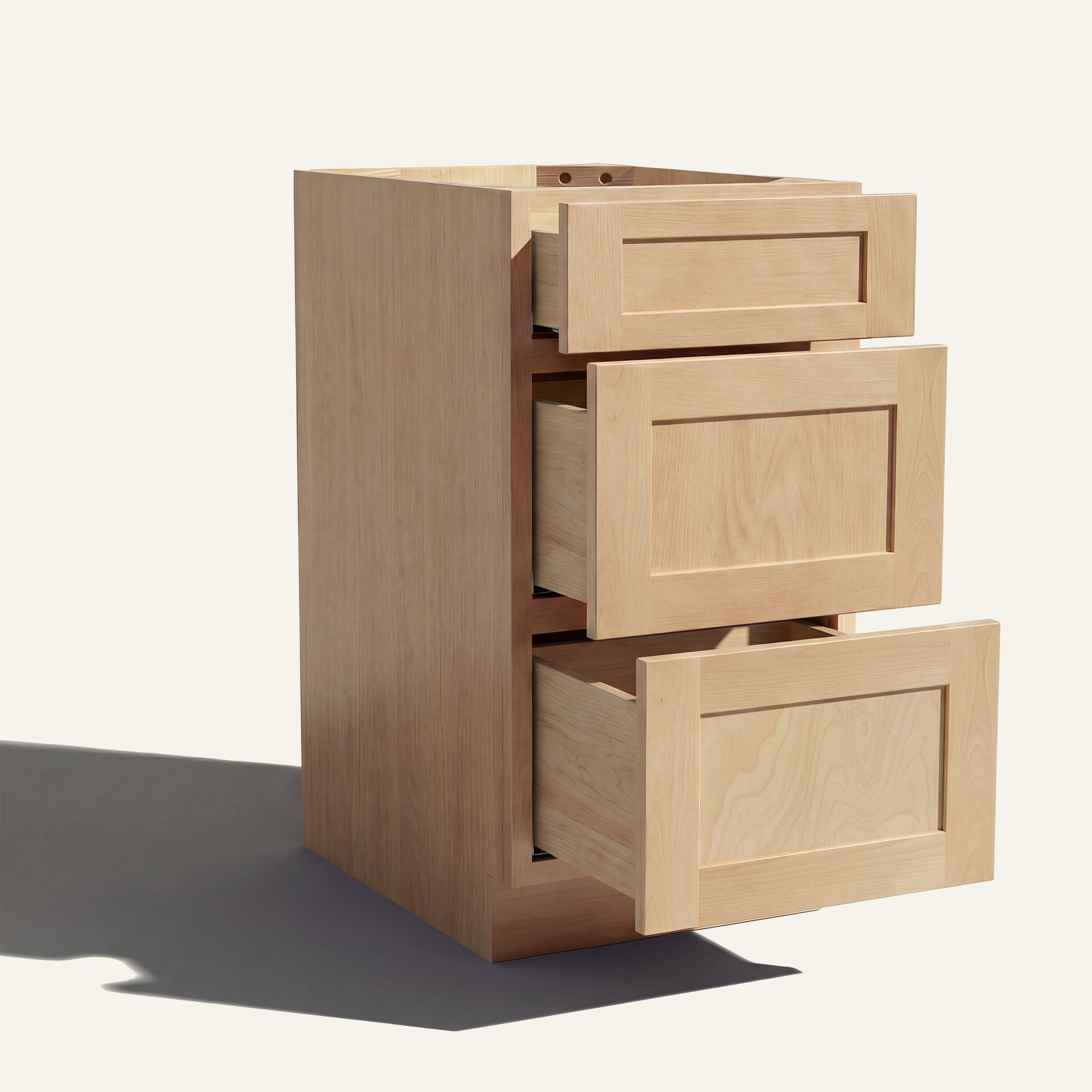 Angled view of a natural Seaport Shaker 3-drawer vanity base cabinet with drawers open showing solid wood drawer boxes.