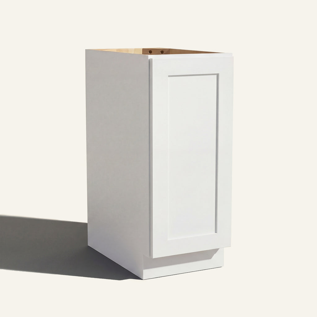 Angled view of a white Seaport Shaker base cabinet with 1 full-height door.