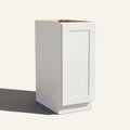 Angled view of a white Seaport Shaker base cabinet with 1 full-height door.