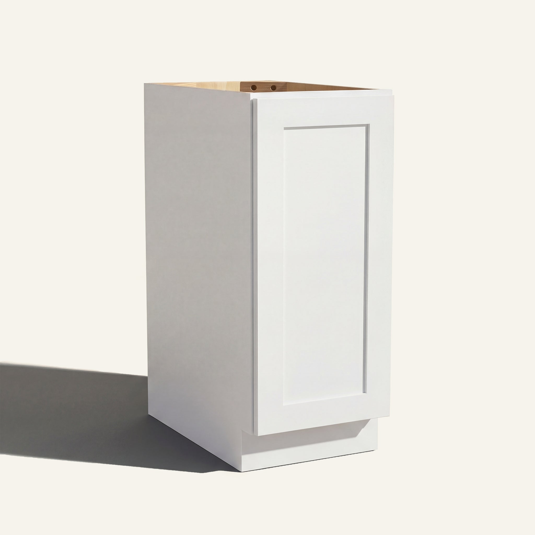 Angled view of a white Seaport Shaker base cabinet with 1 full-height door.