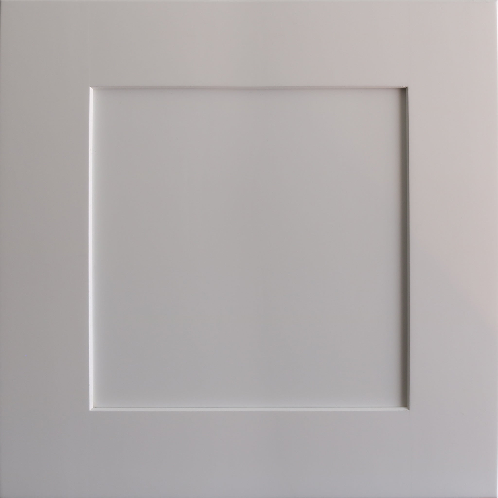Close up view of a white Seaport shaker cabinet door with a recessed square panel.