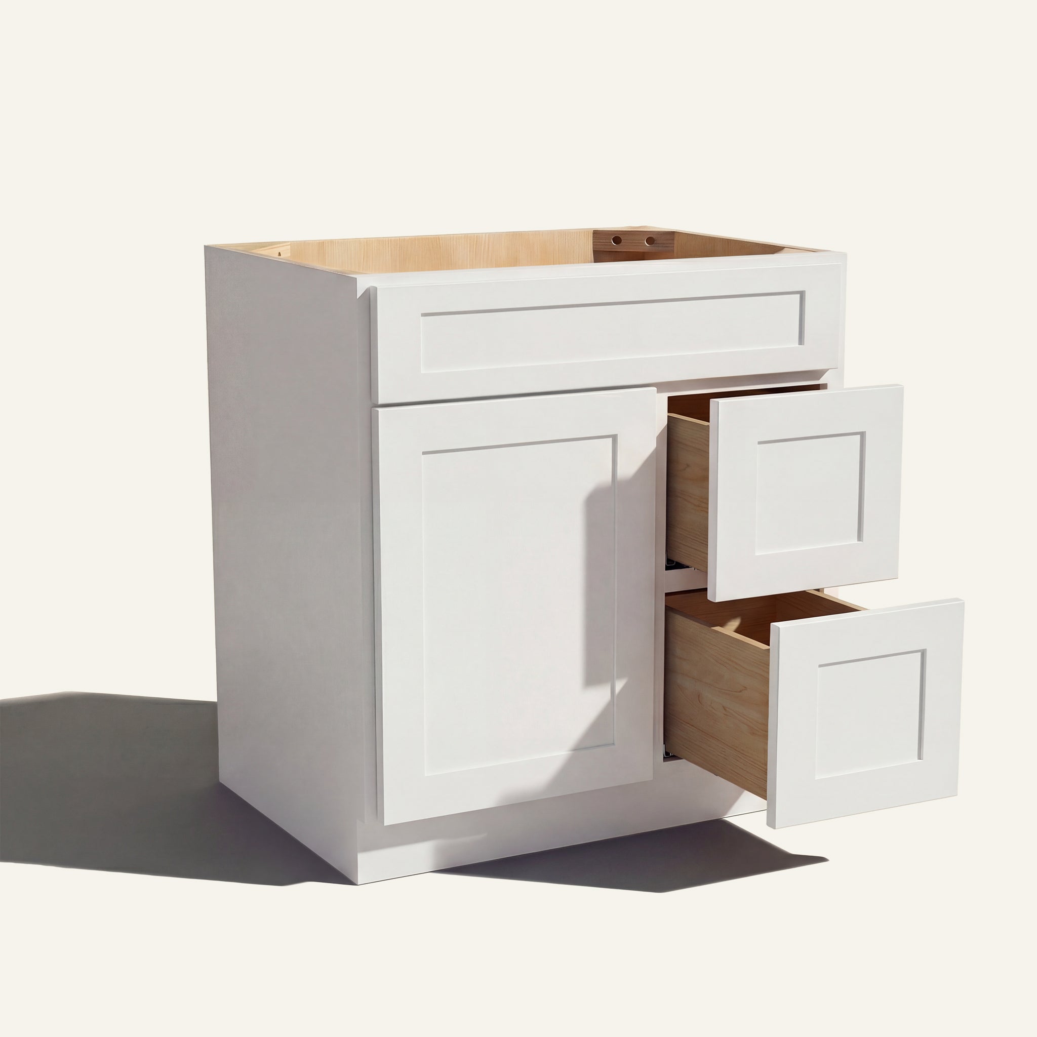 Warm bathroom scene of a white Seaport shaker single sink vanity with 1 door, 2 drawers right, and 1 false front.