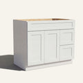 Angled view of white Seaport Shaker single sink vanity, 2 doors, 2 drawers right, and 1 false drawer front.