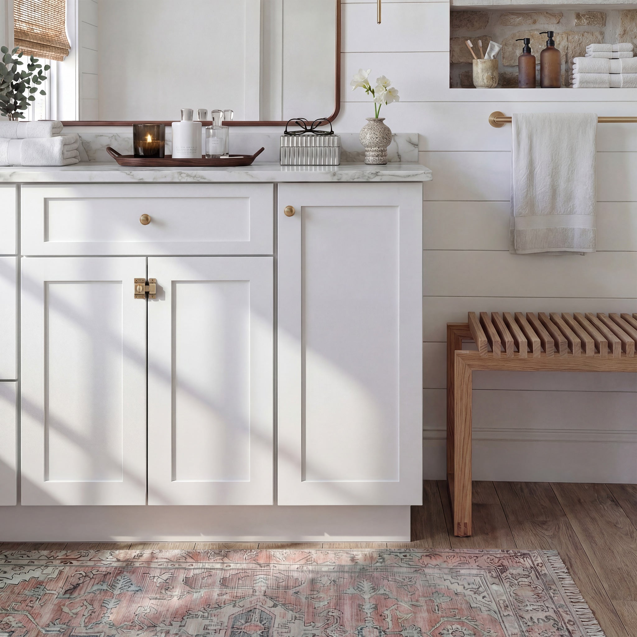 Front view of a white Seaport traditional vanity base cabinet with 3 doors and 1 drawer in a styled bathroom.