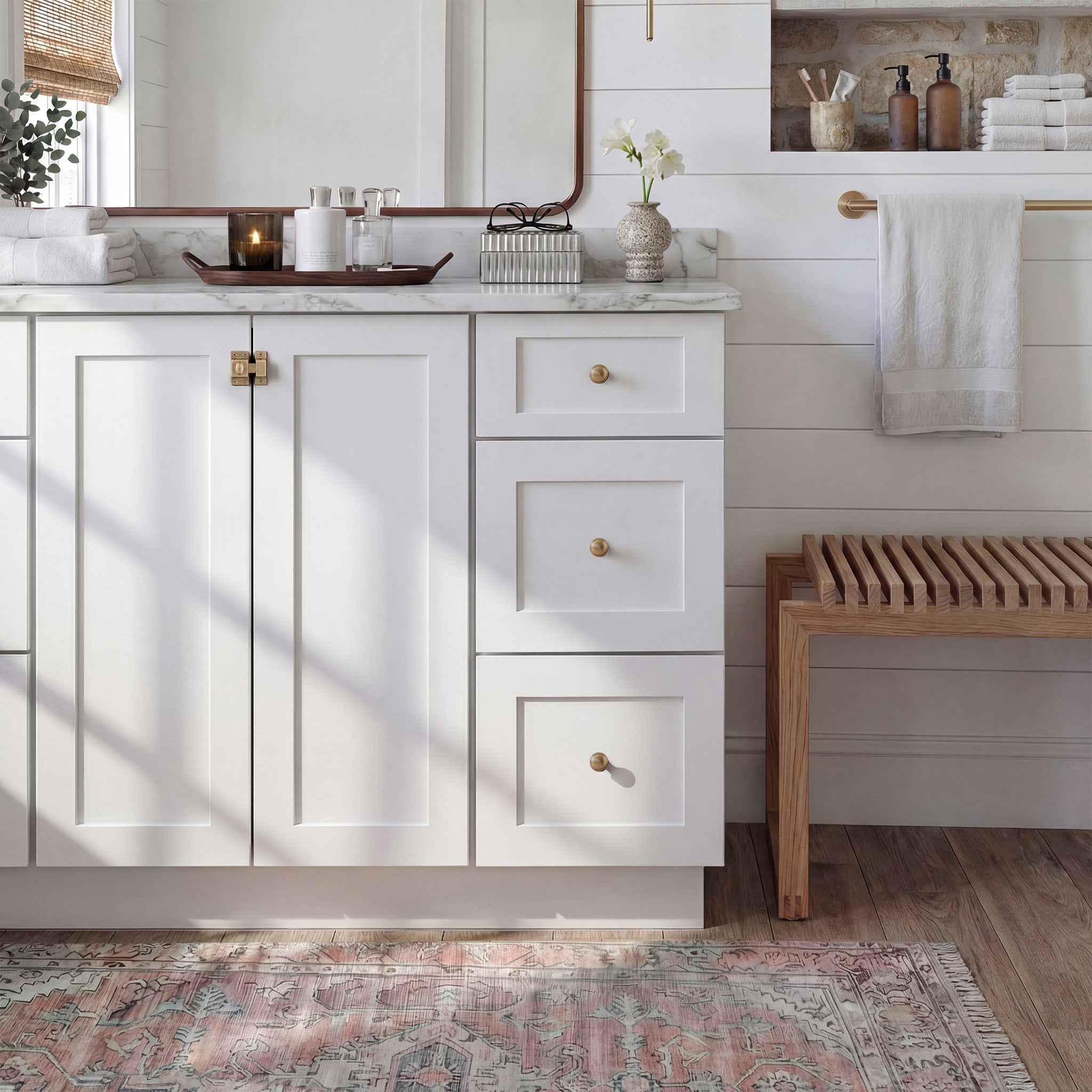 Front view of a white Seaport traditional vanity base cabinet with 2 full-height doors and 3 drawers in a styled bathroom.