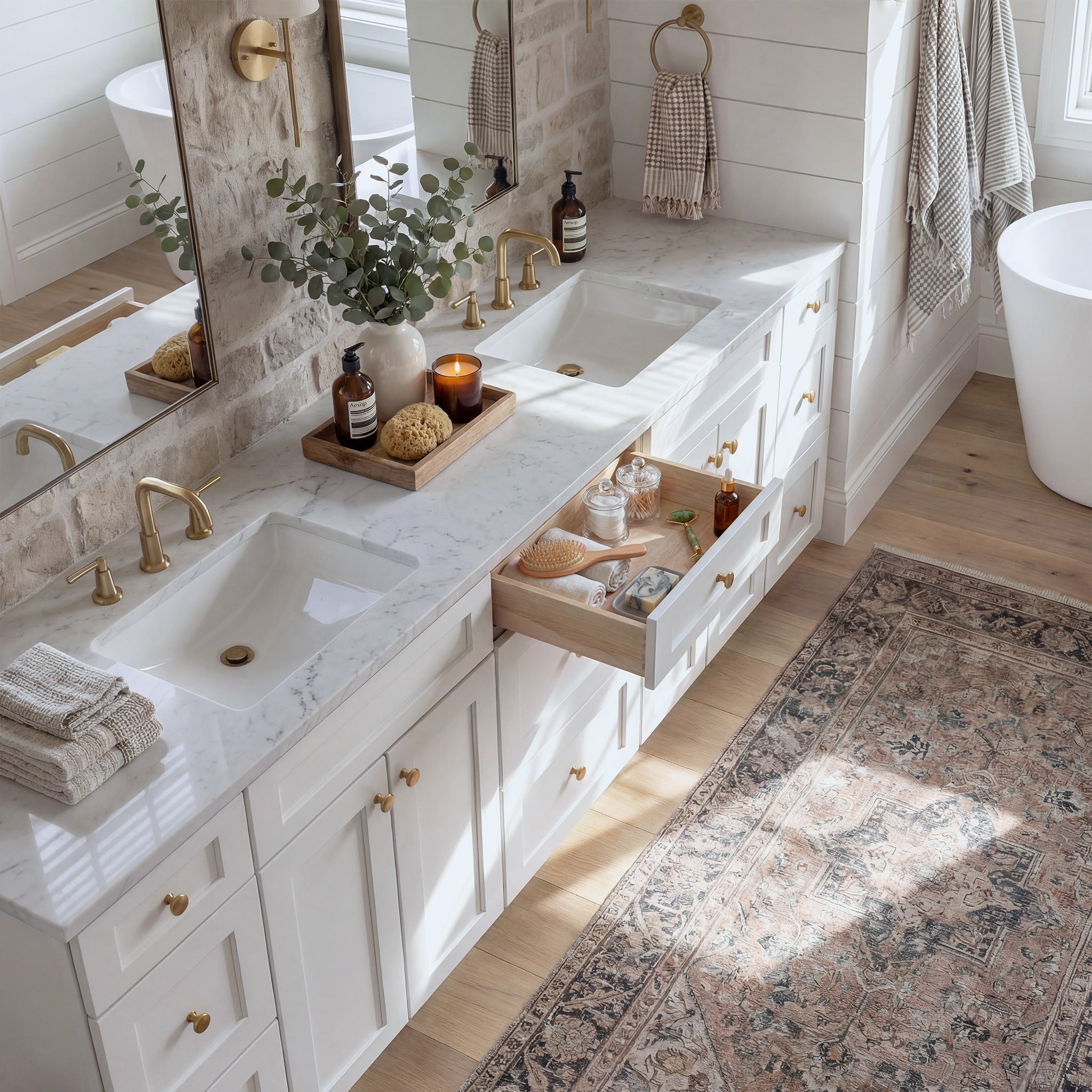 Top-down angled view of a white Seaport shaker vanity with an open drawer, lived-in feel, and Mont Blanc quartzite counter.