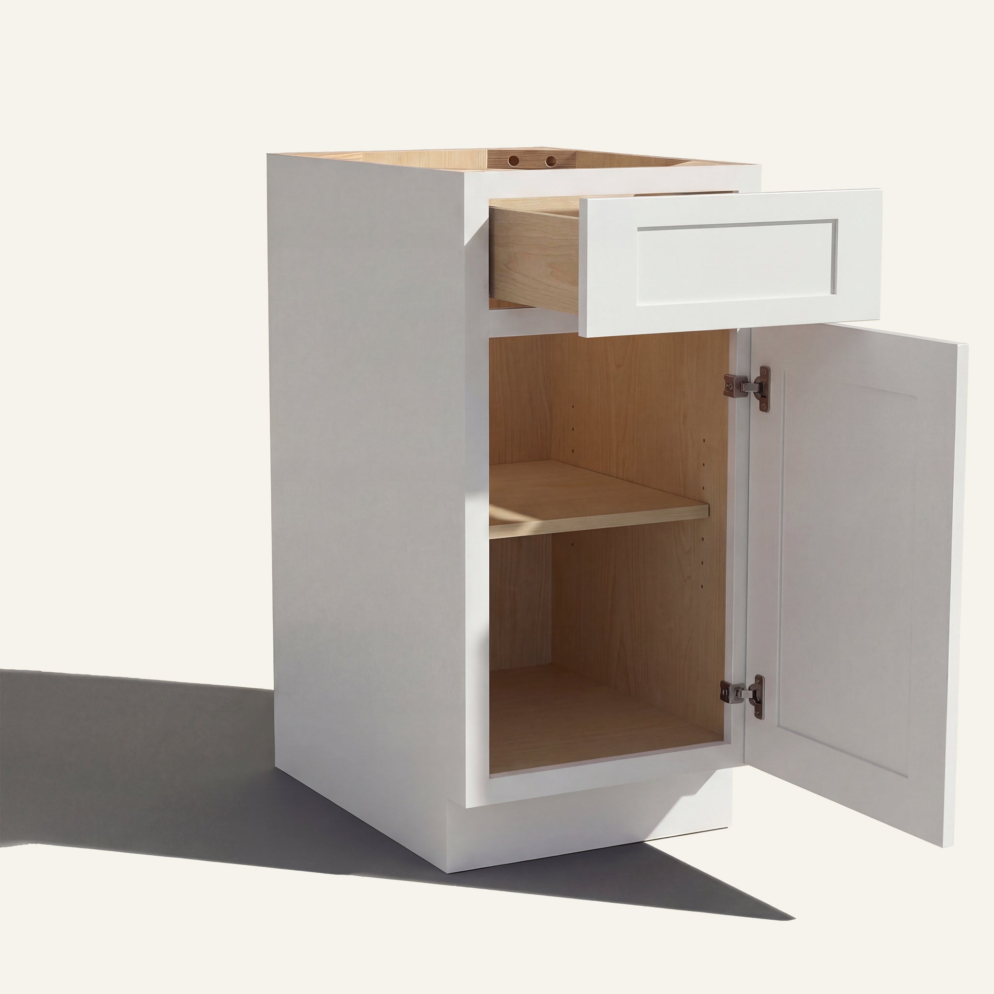 Angled view of a white Seaport Shaker vanity base cabinet with 1 door and 1 drawer open showing wood interior.